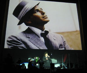 Frank Sinatra in backdrop as Connie sings one of his songs