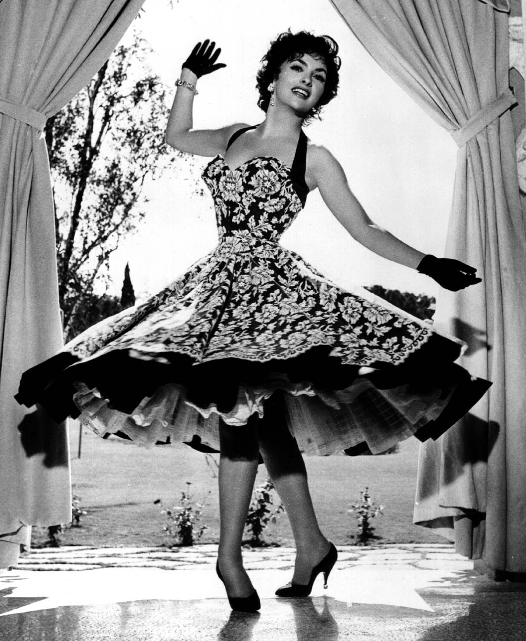 Gina twirling in a pretty dress